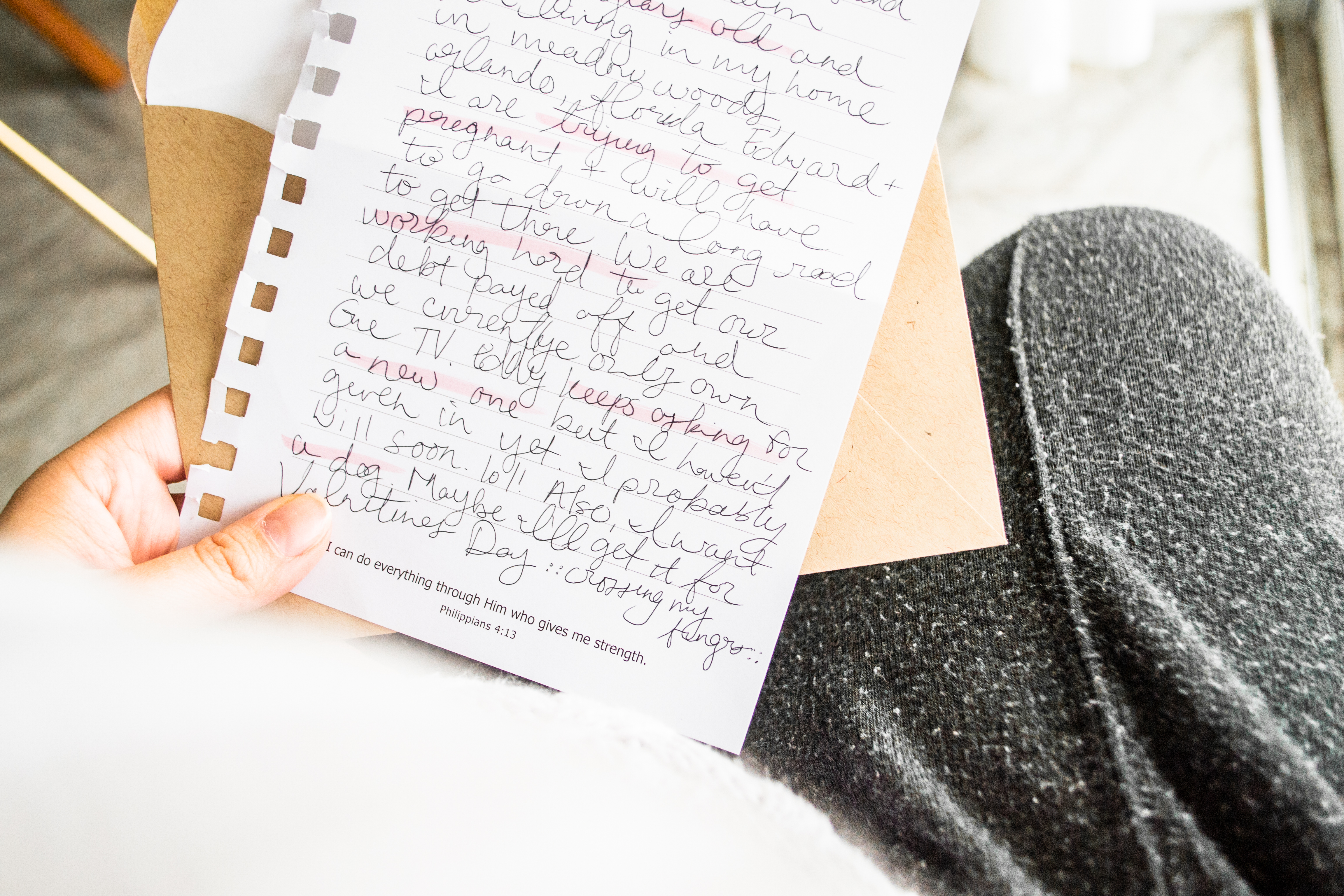 Women in cozy clothes holding and reading hand written note